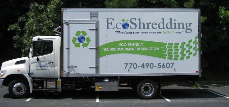 EcoShedding mobile shredding truck in parking lot in front of trees