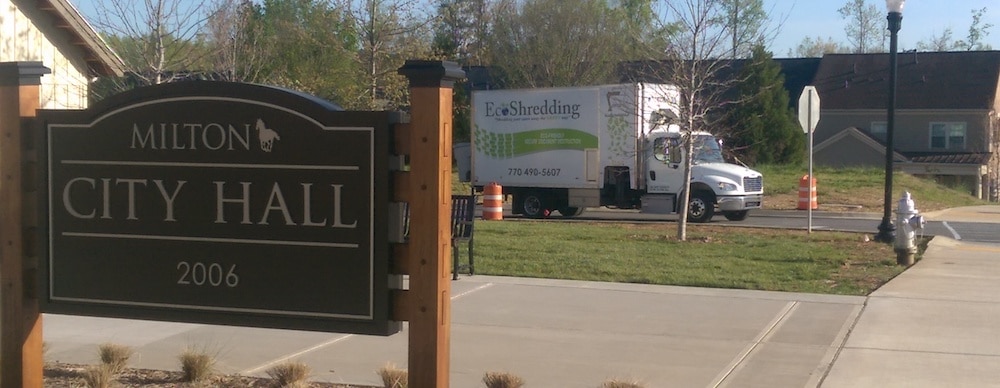 Milton City Hall sign with EcoShredding truck in background