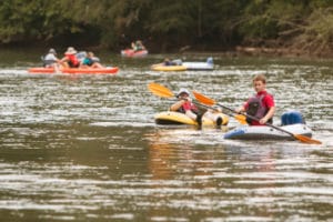 People raft kayak and canoe down the Chattahoochee River on a hot summer day on the Chattahoochee River in Georgia