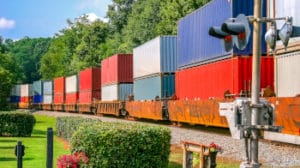 Colorful Freight Train across railroad crossing in Norcross, Georgia