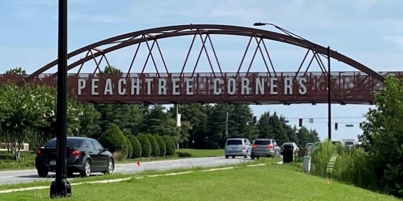 Photo of bridge with sign saying Peachtree Corners - representing shredding service are for EcoShredding